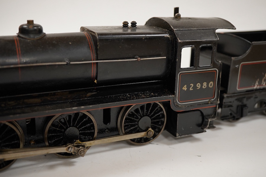 An 0 gauge Bassett-Lowke live steam spirit fired tinplate BR 2-6-0 Mogul tender locomotive, 42980, with original fuel tank and burner, two controls in the cab accessed through the cab roof